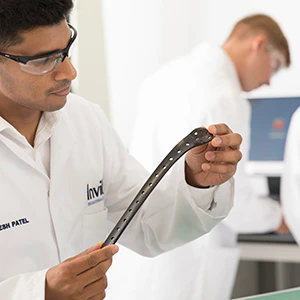 Invibio employee inspecting a trauma plate