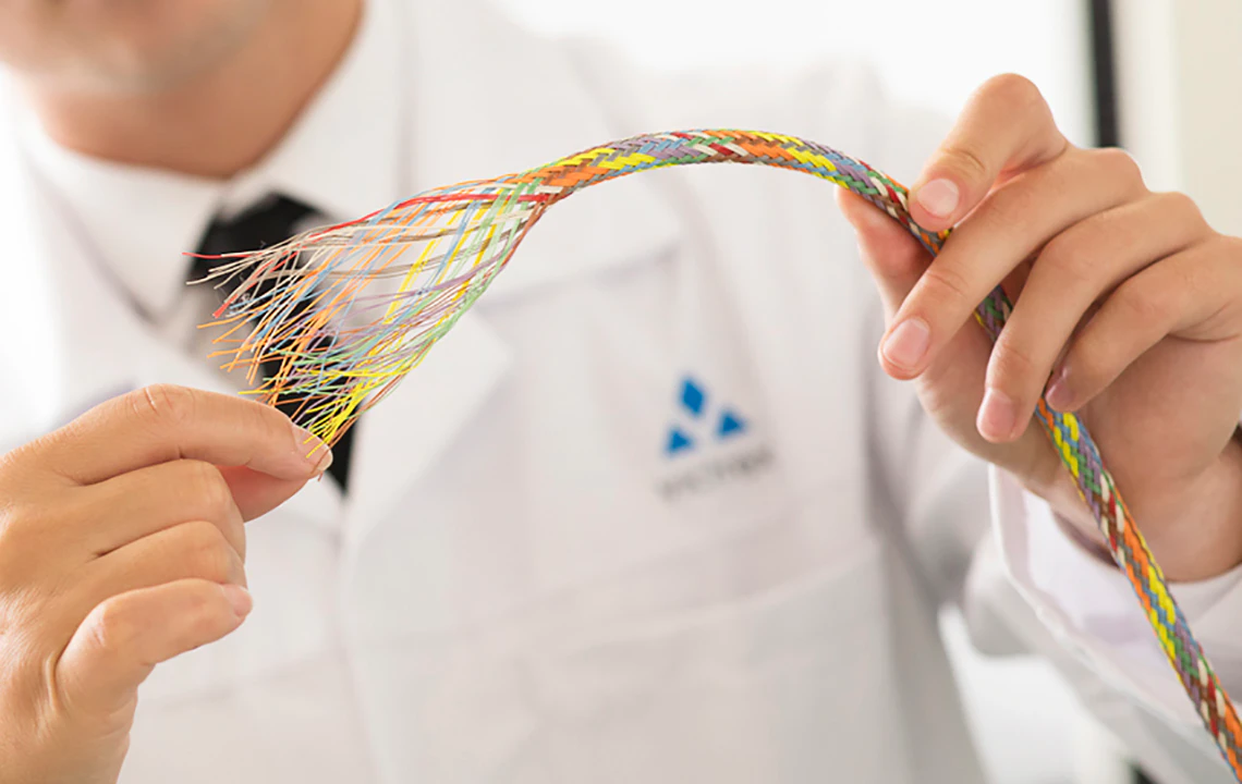 Multicolored ZYEXTM PEEK fiber strands showing flexibility